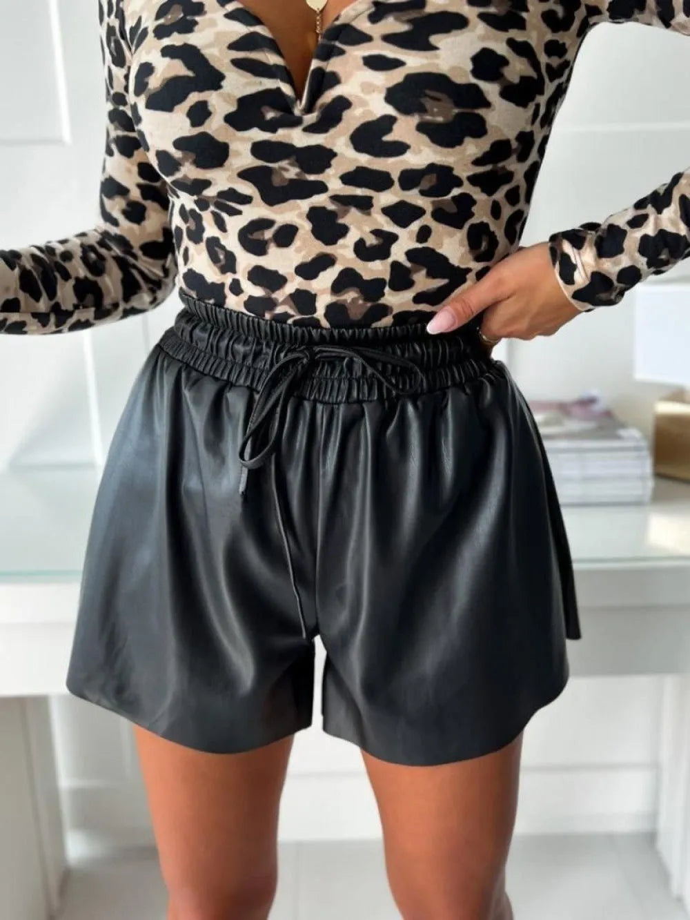 Black women's wide-leg casual shorts with a drawstring lace-up waist and PU leather trim.