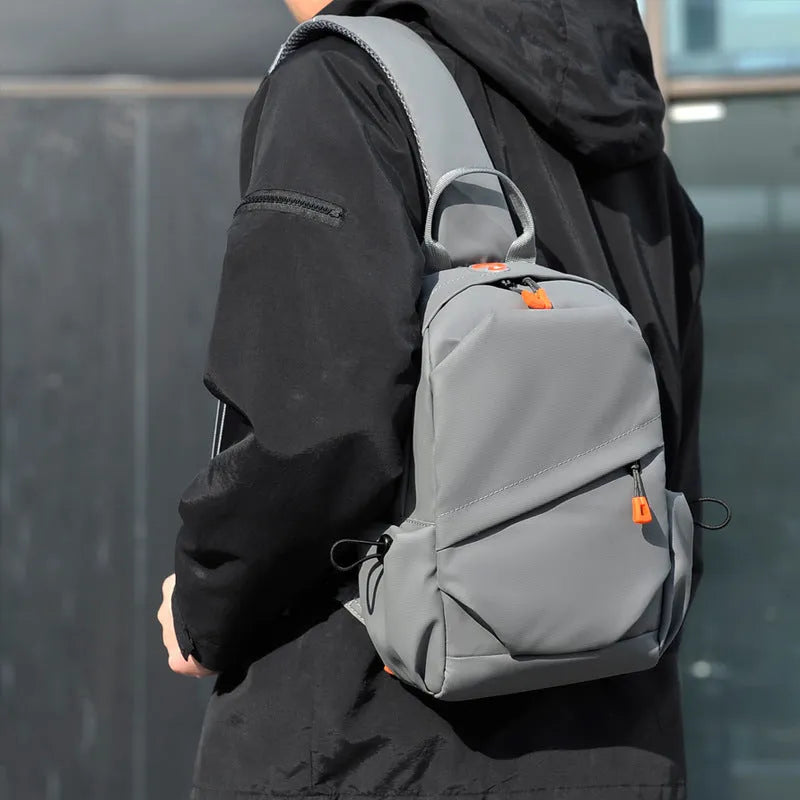 Mens black casual crossbody bag with single shoulder strap, made from waterproof polyester