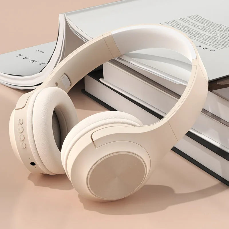 Wireless Bluetooth over-ear headphones in ivory white, chalk black, or youth green with a portable charging case.