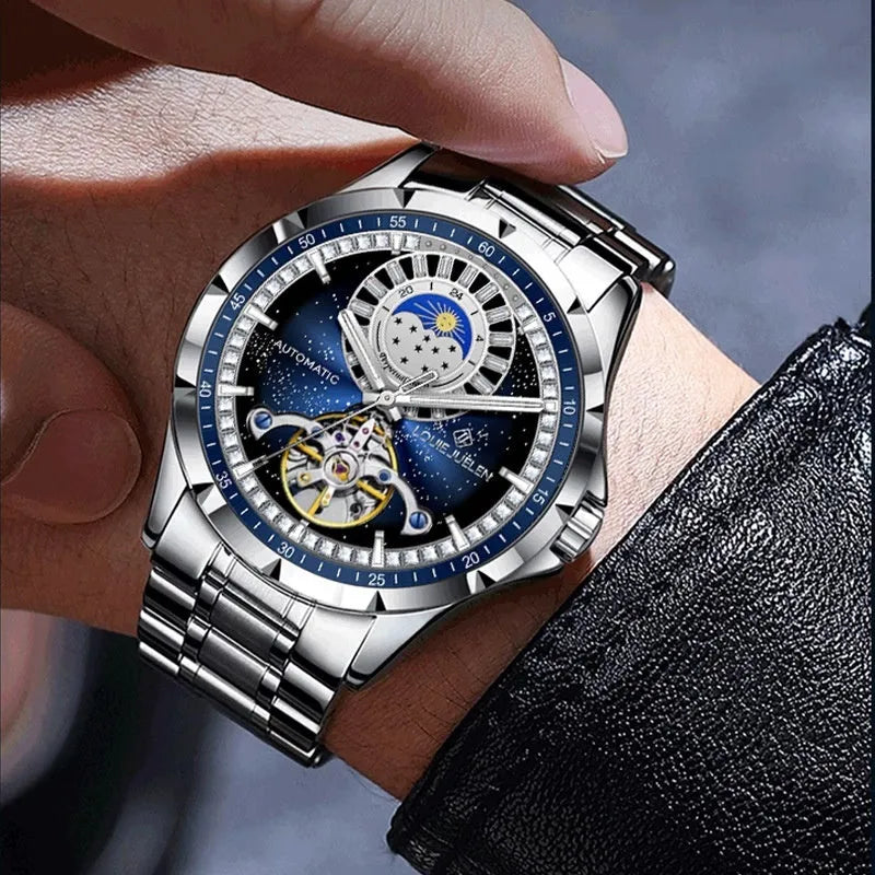 Men's silver alloy automatic mechanical watch with blue dial and stainless steel strap on wrist.