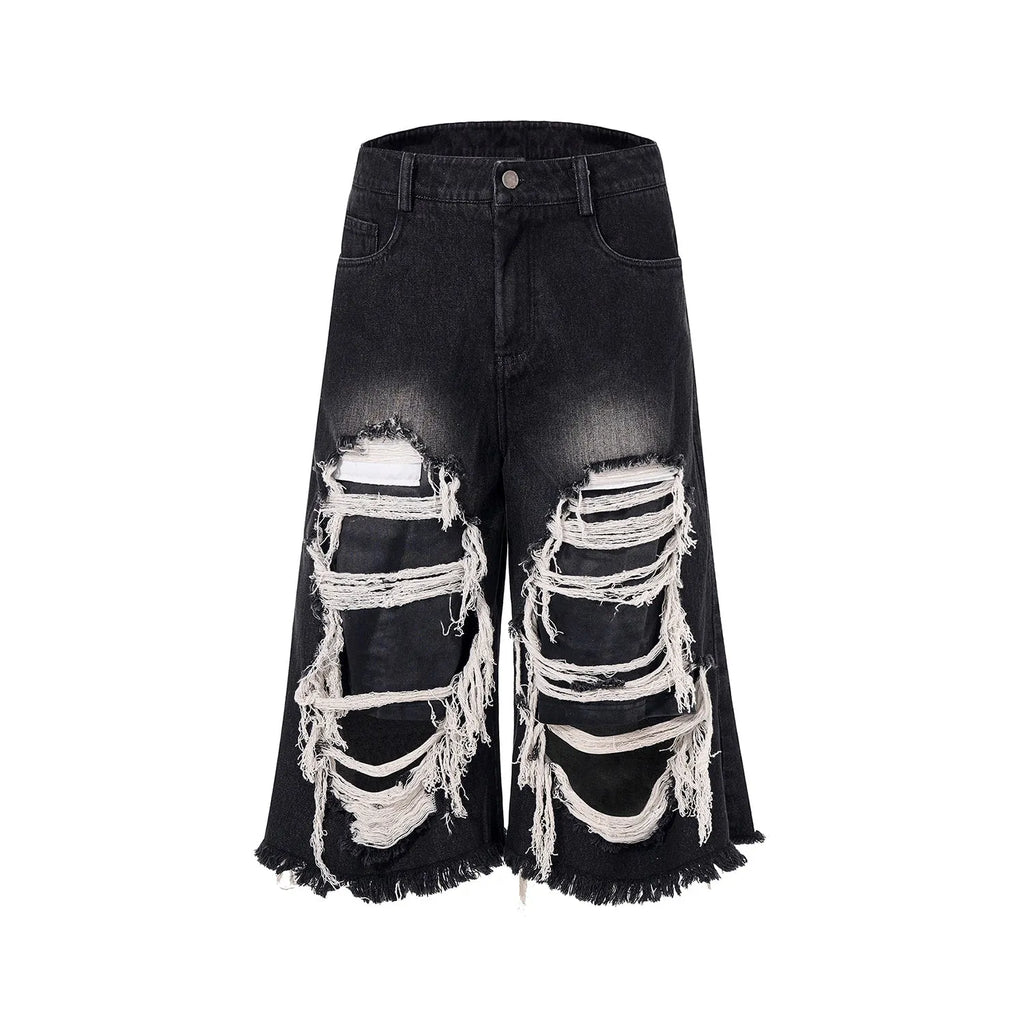 Black women's wide-leg cropped jeans with ripped patchwork details on cotton denim.