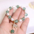 Green strawberry freshwater pearl bracelet with Chinese knot and peace buckle fastening