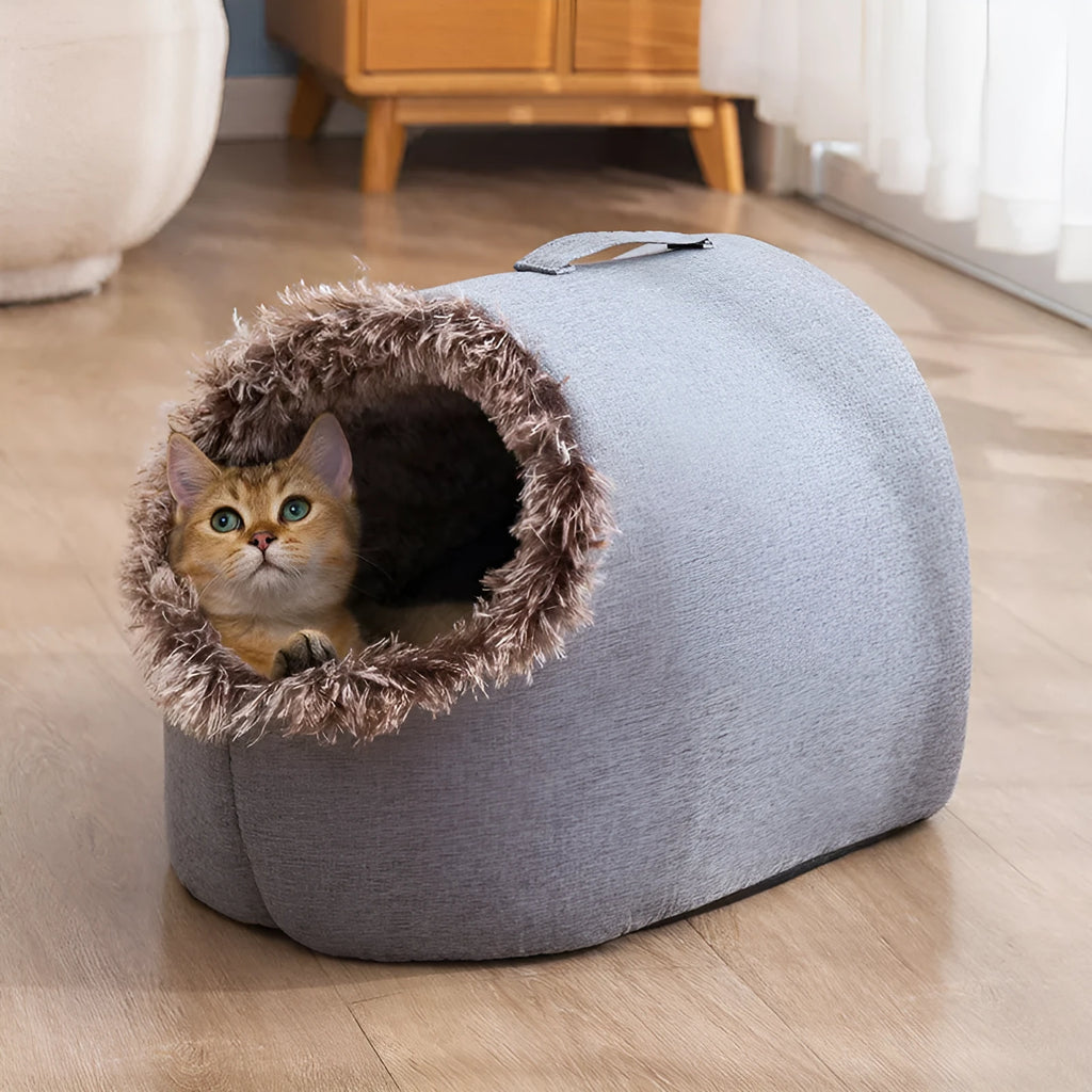 Grey fleece-lined enclosed cat sleeping bag bed for pets in a cage.