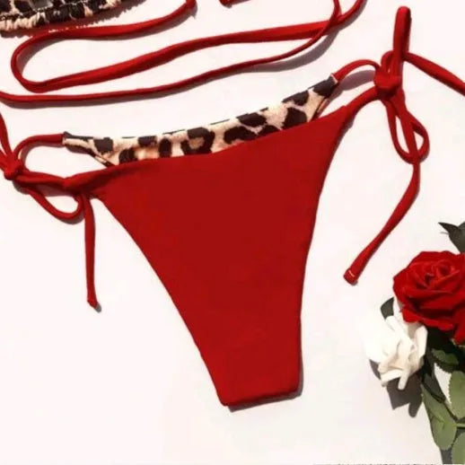 Women's red leopard print halter bikini with lace-up front on a mannequin