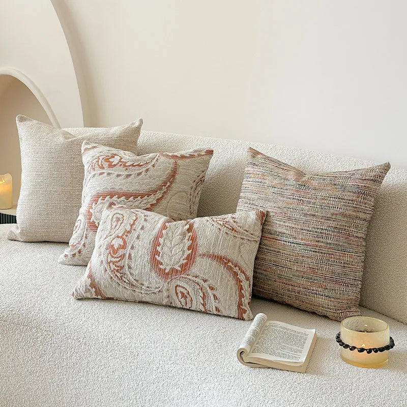 American-style jacquard woven throw pillow cover with a paisley pattern in amber colours on a sofa.