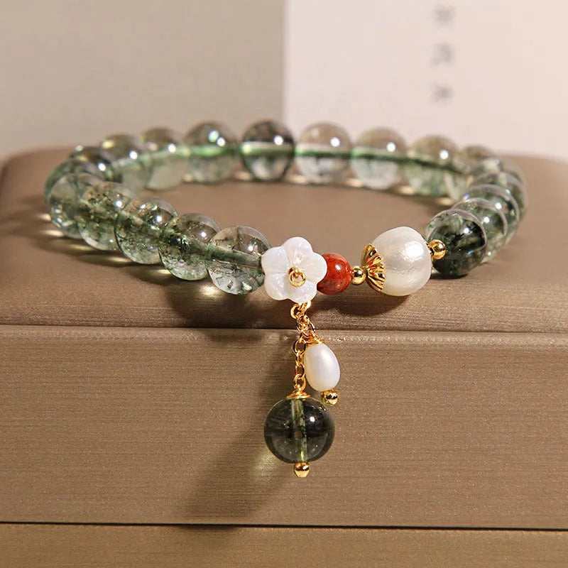 Green phantom quartz crystal bracelet with Bells of Ireland and shell flower design
