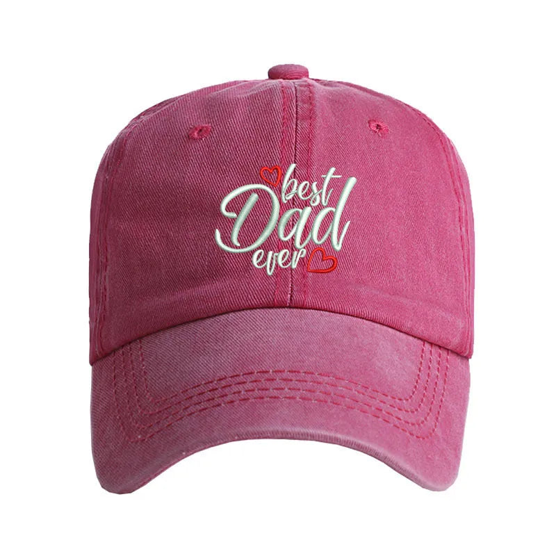 Red washed cotton baseball cap with white embroidered letters on the front, showing adjustable strap at back.