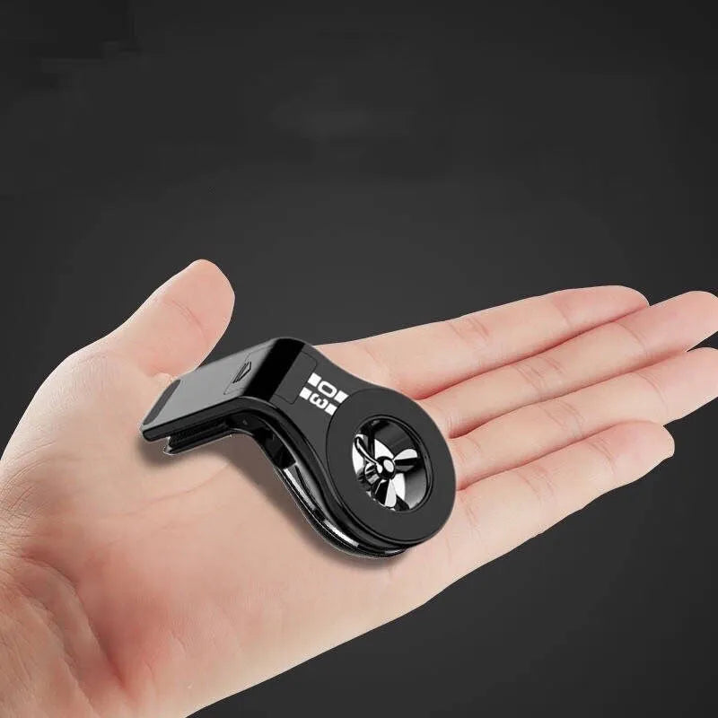 Black magnetic car phone holder mounted on vehicle air vent with smartphone attached