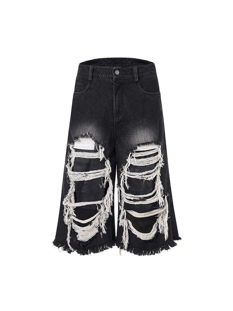 Black women's wide-leg cropped jeans with ripped patchwork details on cotton denim.