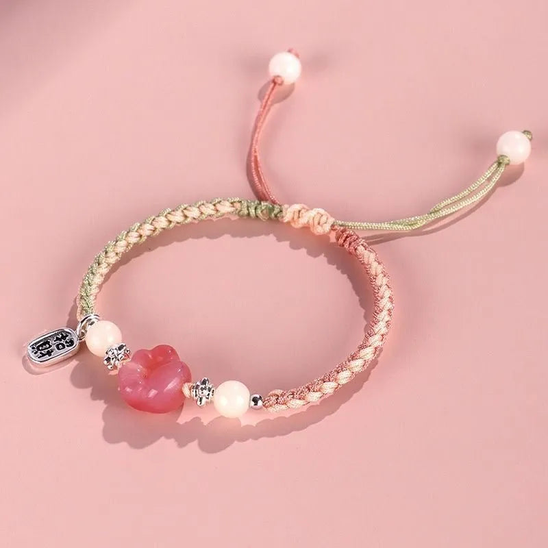 Handmade red cat's paw charm bracelet with pink woven band for couples.