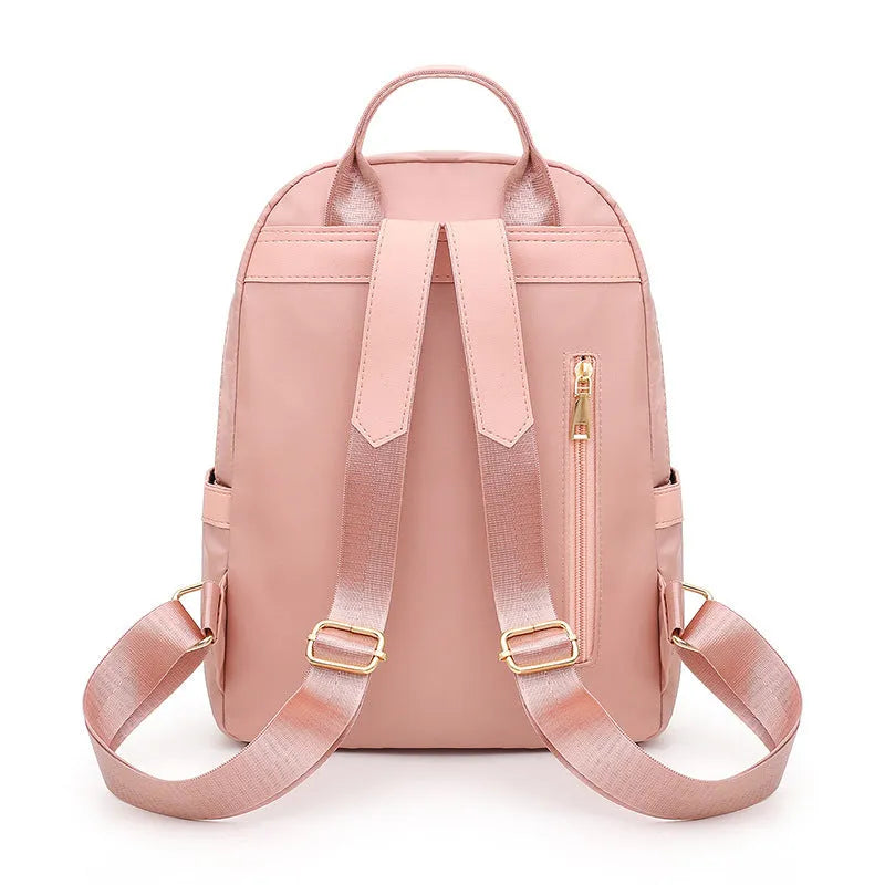 Black nylon casual backpack with external pockets, shown with adjustable straps and a soft handle.