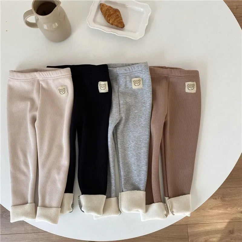 Girls' high-waist fleece-lined leggings in beige, shown with elastic hairband belt detail.