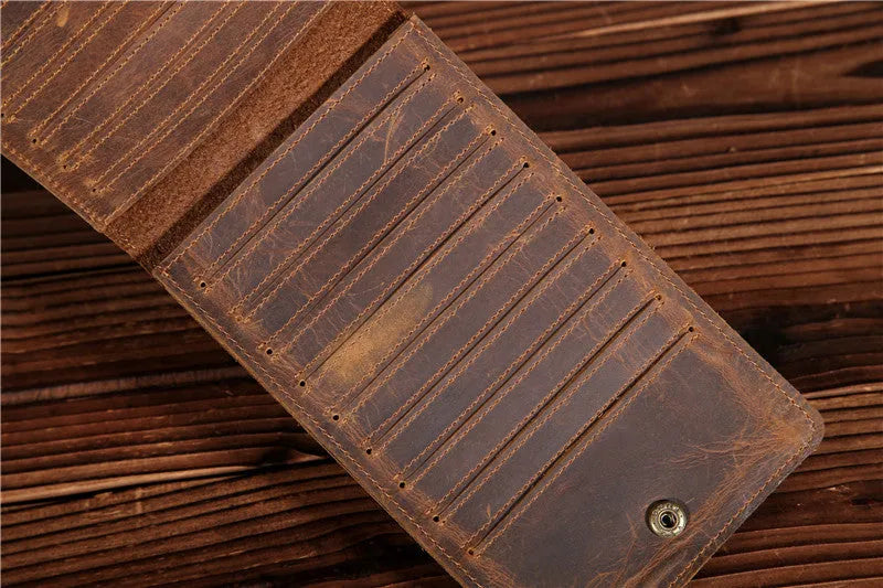 Slim black leather men's wallet open to show 18 card slots and a central mobile phone pocket.