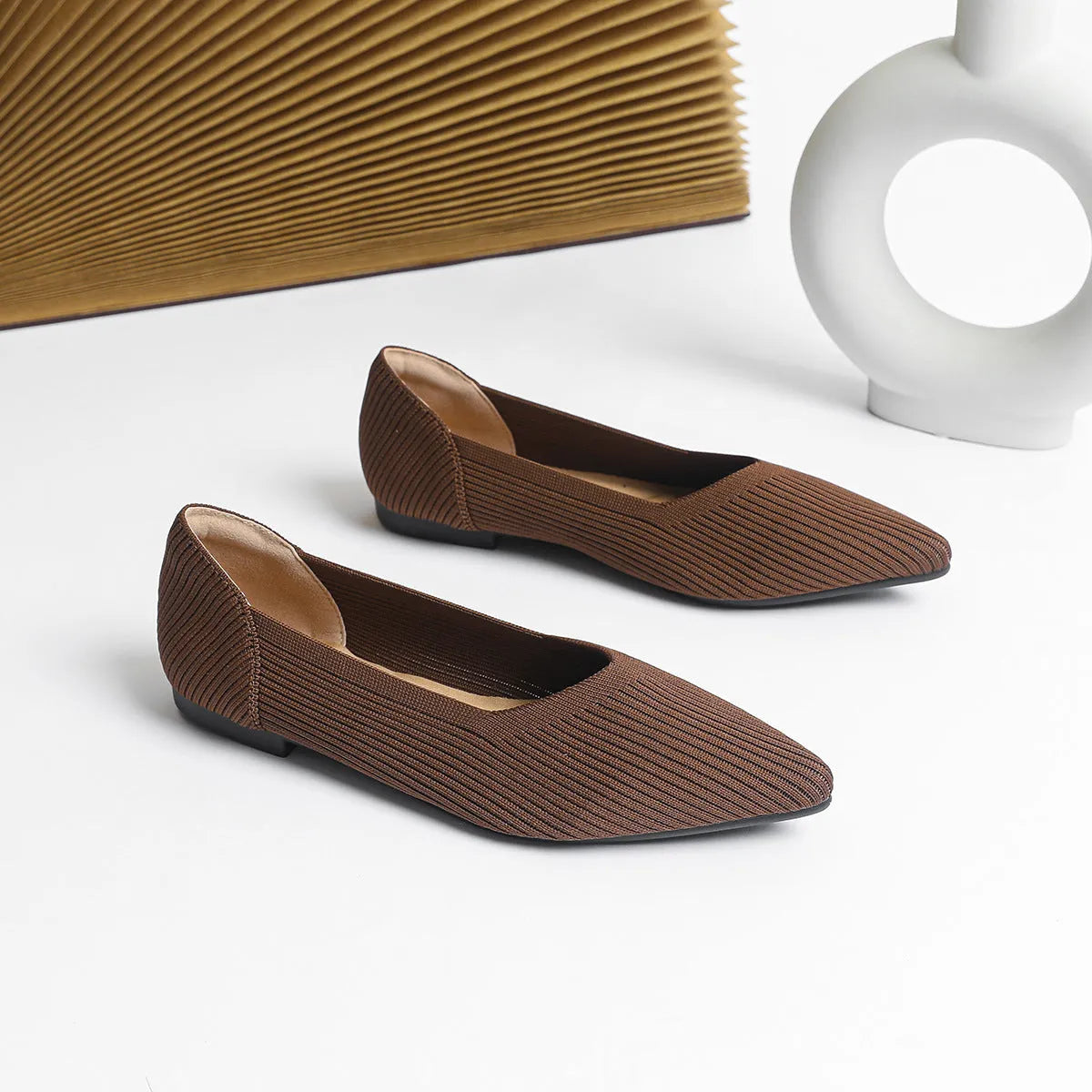 Women's knit flat pumps with pointed toe and rubber sole available in multiple colours