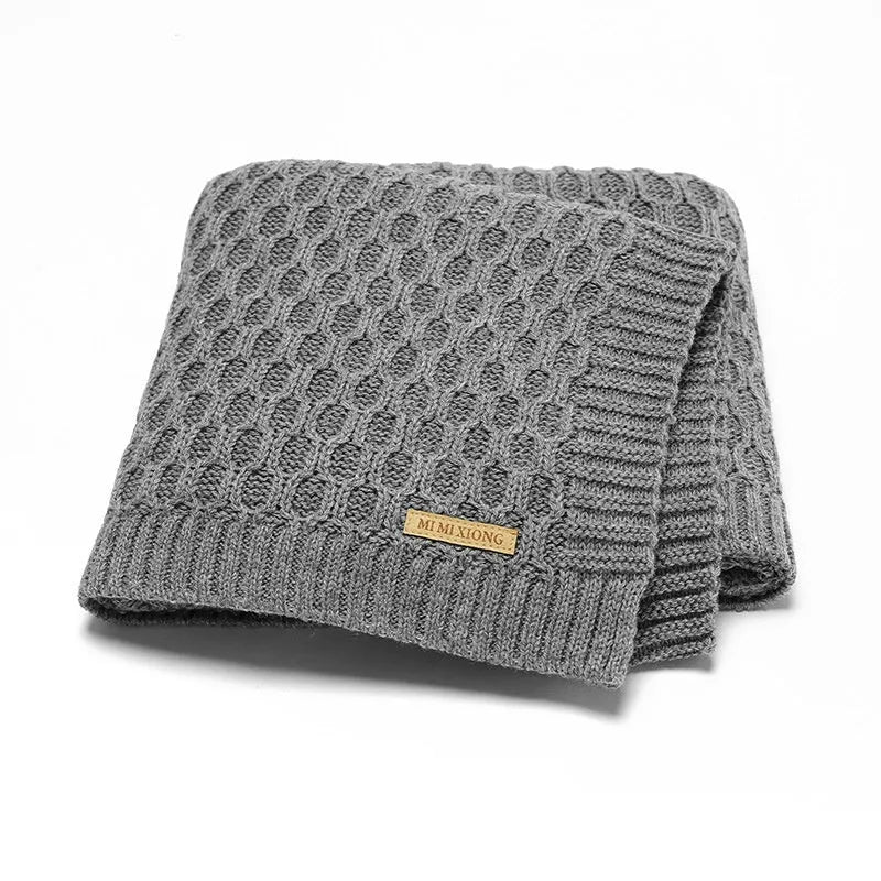 Solid colour baby hug blanket with raised line texture, shown in a light green colour.