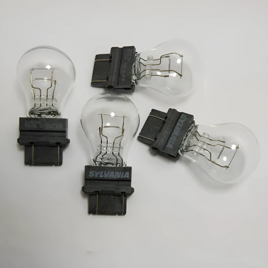 Wagner brake light bulb with yellow glass and dual wire connections for industrial equipment lighting