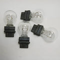 Wagner brake light bulb with yellow glass and dual wire connections for industrial equipment lighting