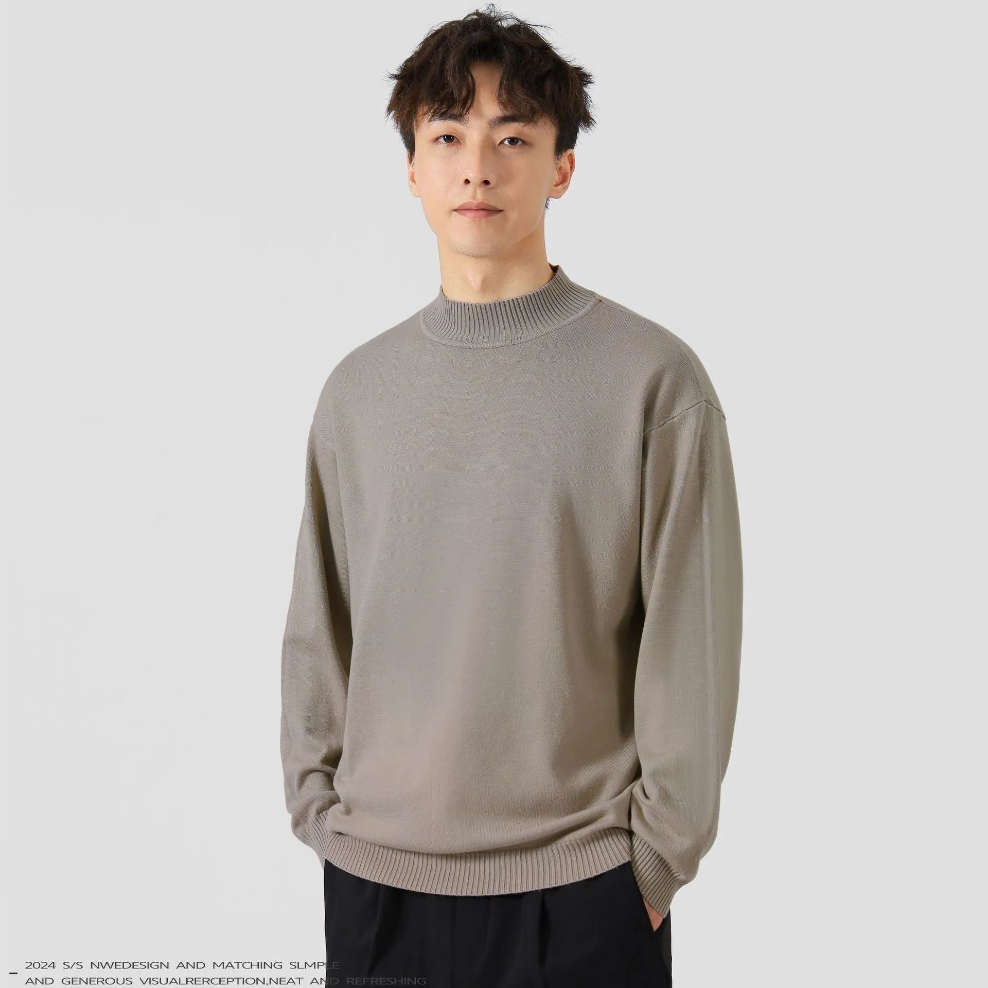 Man wearing a loose-fit army green long sleeve pullover sweater for casual autumn wear.