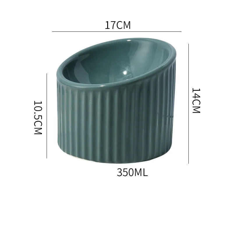 Dark green ceramic raised cat bowl with tilted design on a wooden surface.