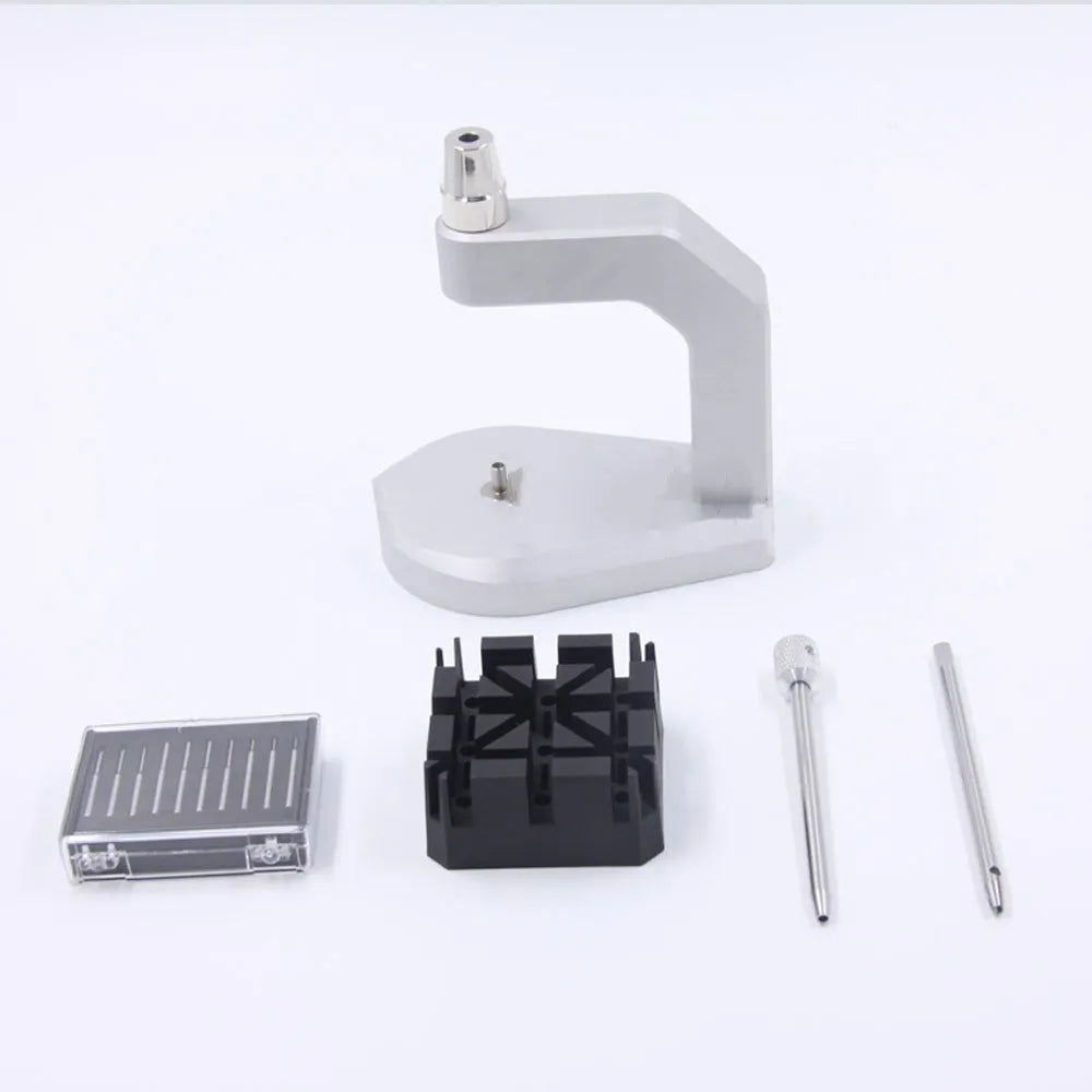 Silver tool steel multi-purpose press strap removal tool on a work surface.