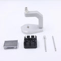 Silver tool steel multi-purpose press strap removal tool on a work surface.
