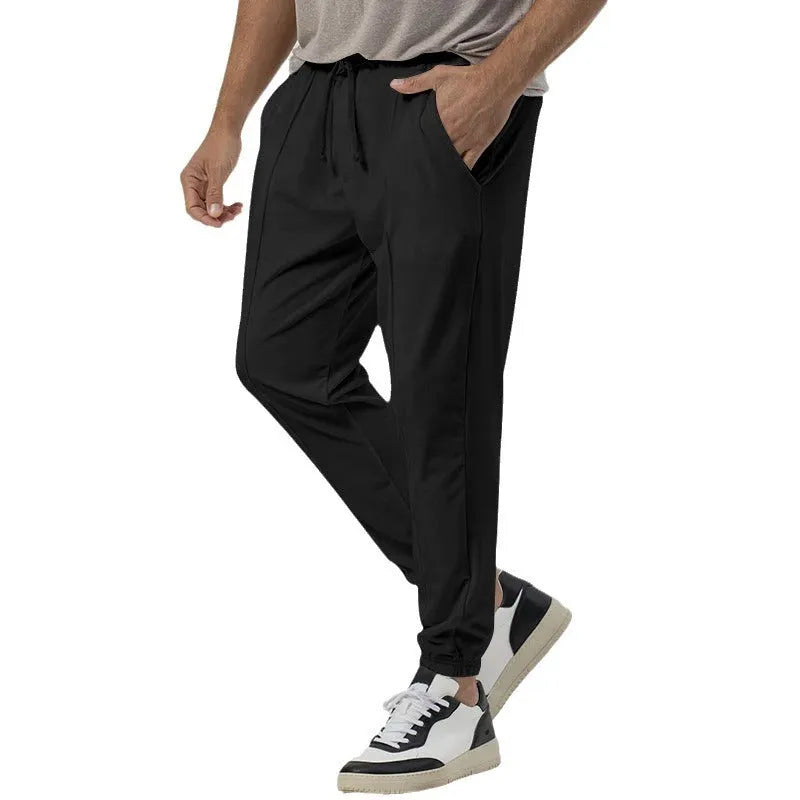 Men's grey casual tapered sweatpants with an elasticated waistband and straight-leg design