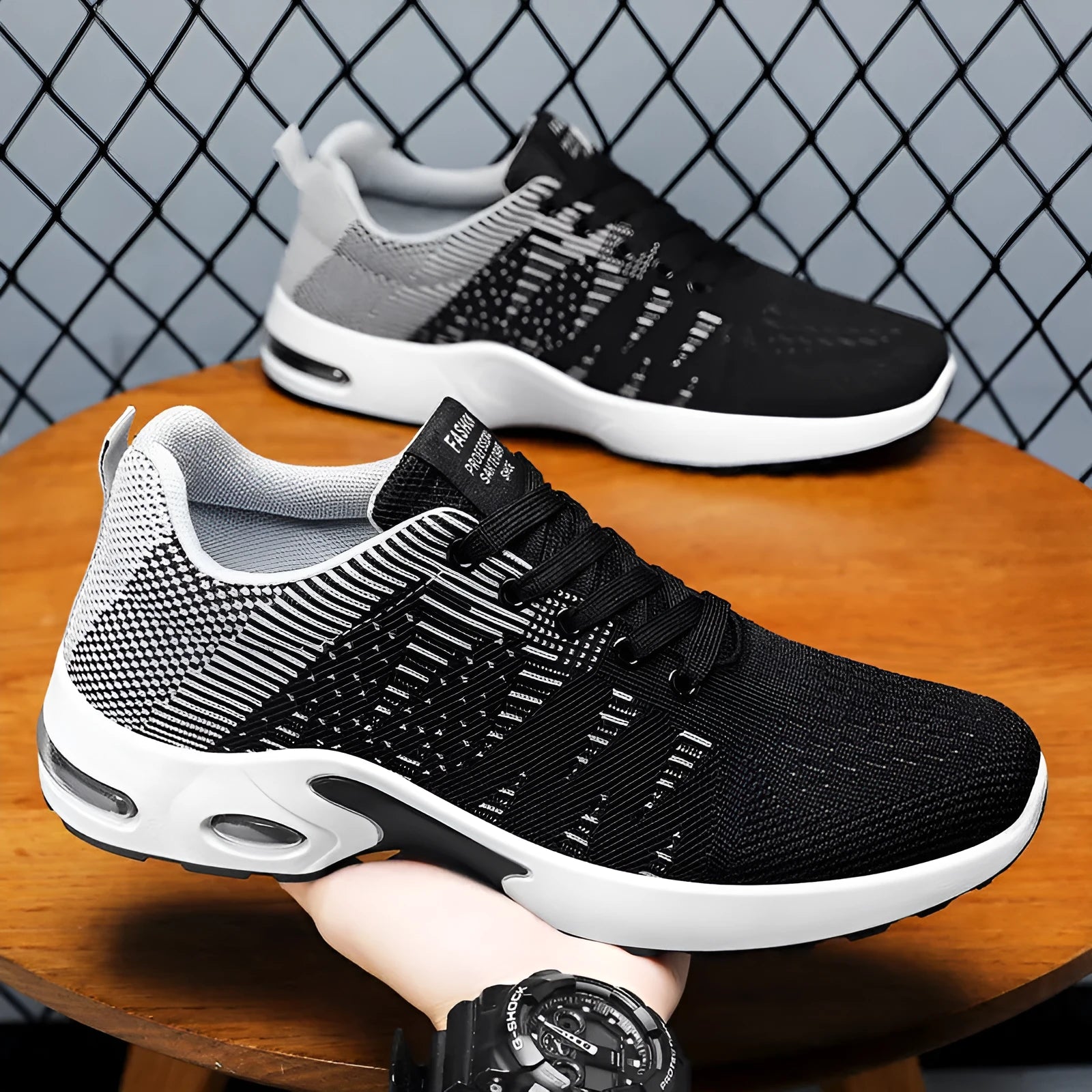 Men's black and grey Flyknit mesh low-top casual sneakers with lace-up front and soft sole.