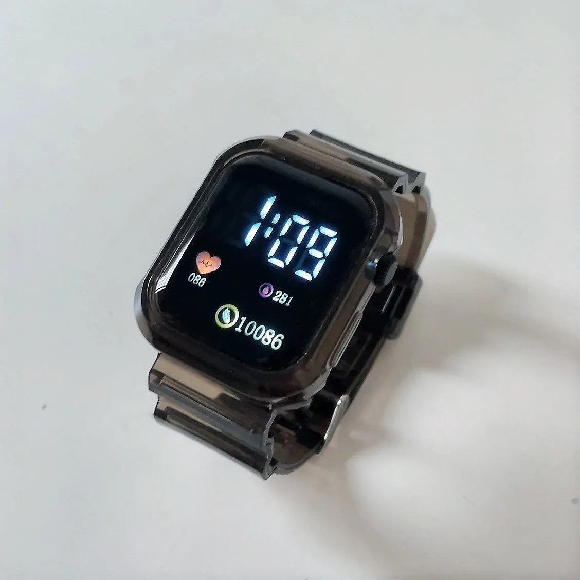 Square LED electronic watch with 45mm rectangle dial, plastic strap, plastic watchcase, transparent colour option.