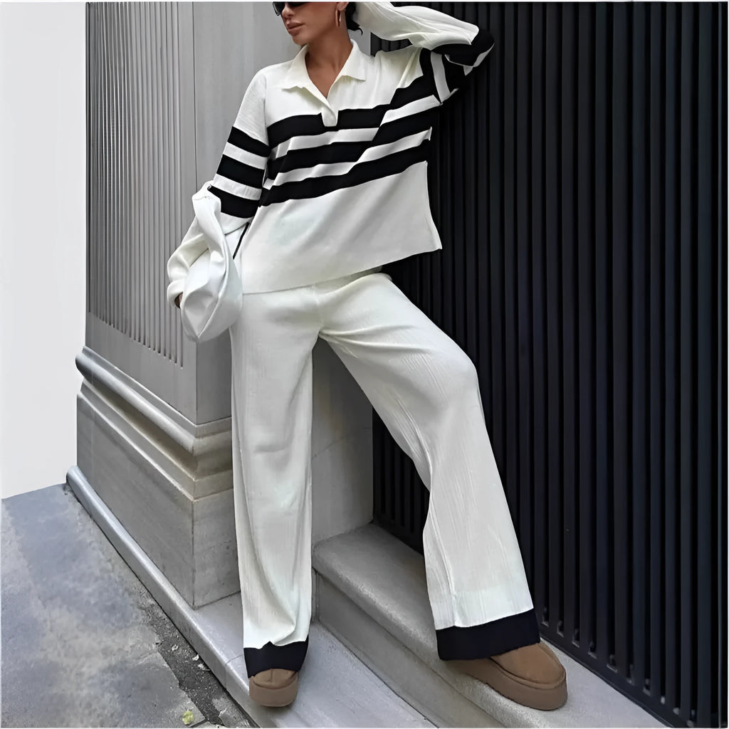 Women's black and white striped knitted top with polo collar and matching trousers casual set.