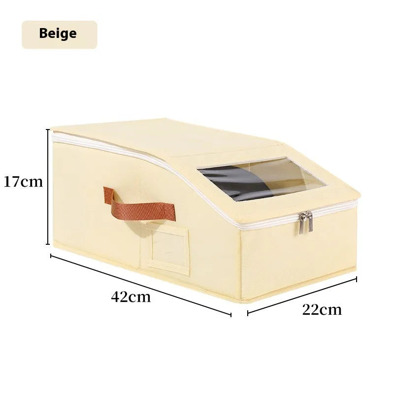 Grey foldable fabric storage box with cover, shown next to a baseball cap.