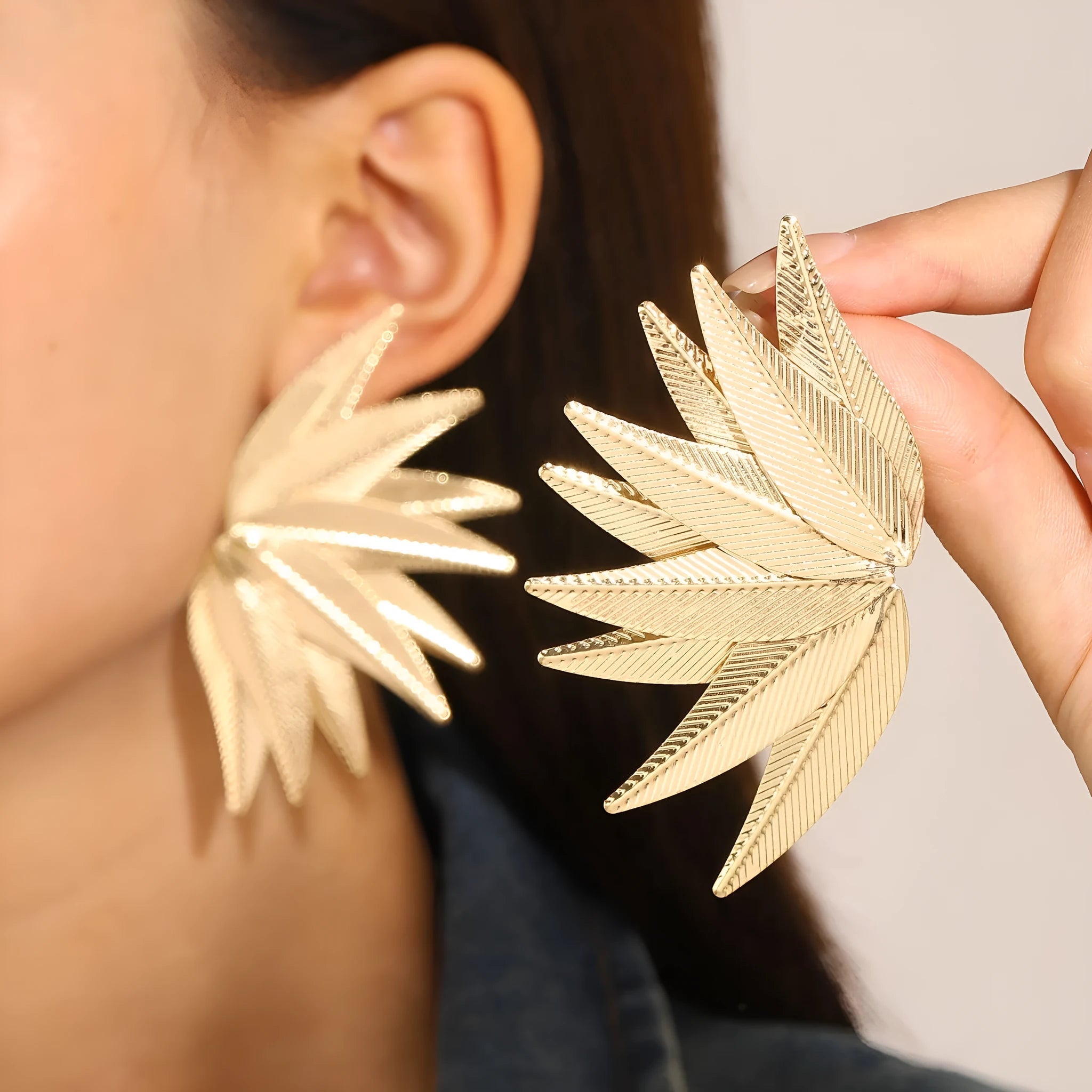 Alloy metal leaf-shaped patch earrings in white and gold colour options