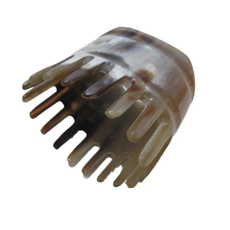 Traditional white buffalo horn comb with wide teeth and pointed tips for meridian massage