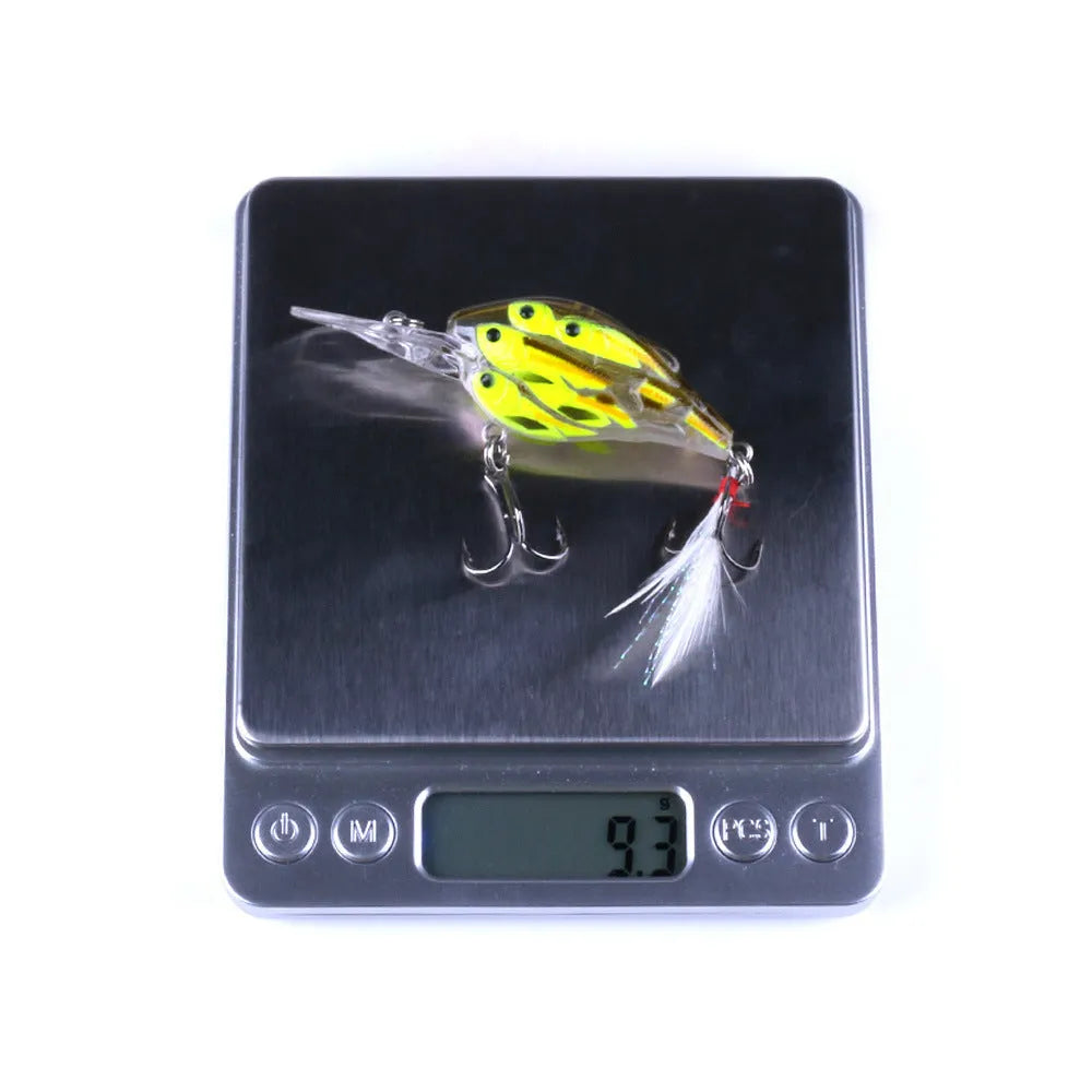 Sea fishing hard bait lure with feather hooks floating on water surface