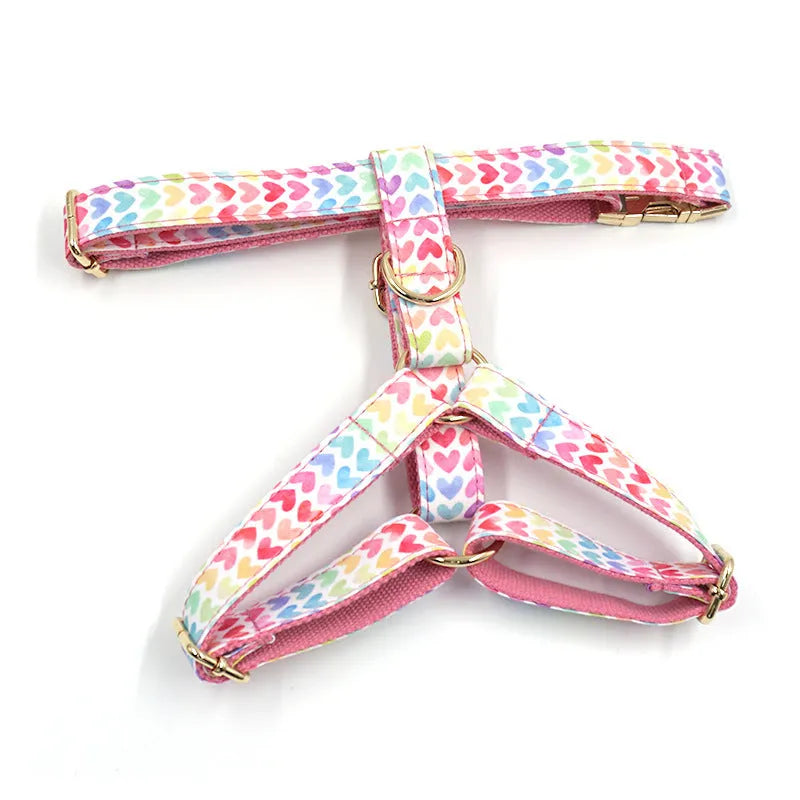 Pink colourful dog harness with heart-shaped stones and gold buckle fastenings on chest and back support design