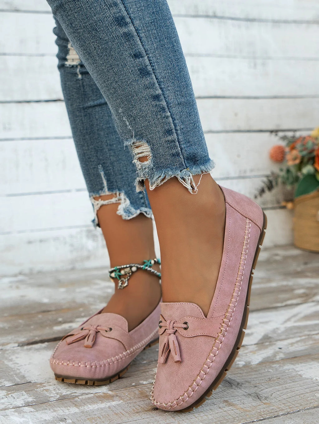 Women's apricot suede flat shoes with a bow detail on the front, showing round toe and low-top design.