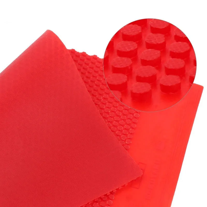 A single sheet of black table tennis rubber with a small pimple texture.