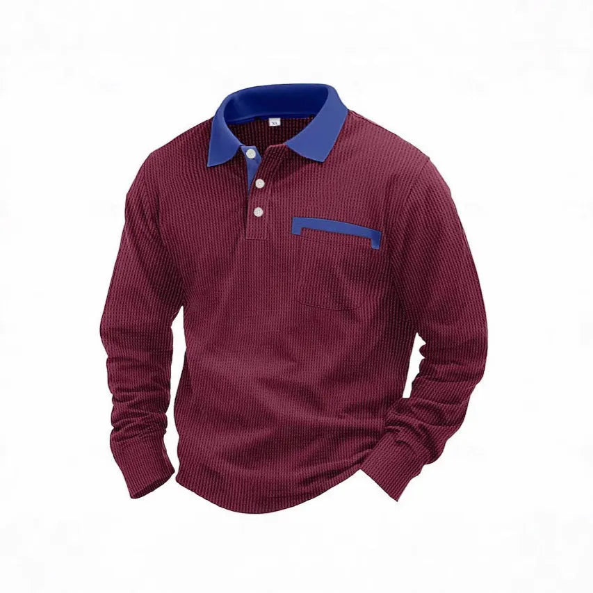 Man wearing a long-sleeved waffle knit polo shirt with an asymmetric collar in a dark colour.