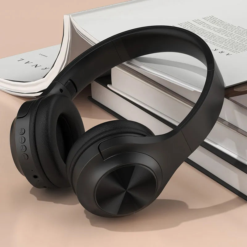 Wireless Bluetooth over-ear headphones in ivory white, chalk black, or youth green with a portable charging case.