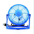 Mini black USB desk fan with adjustable tilt, shown on a desk next to a laptop.