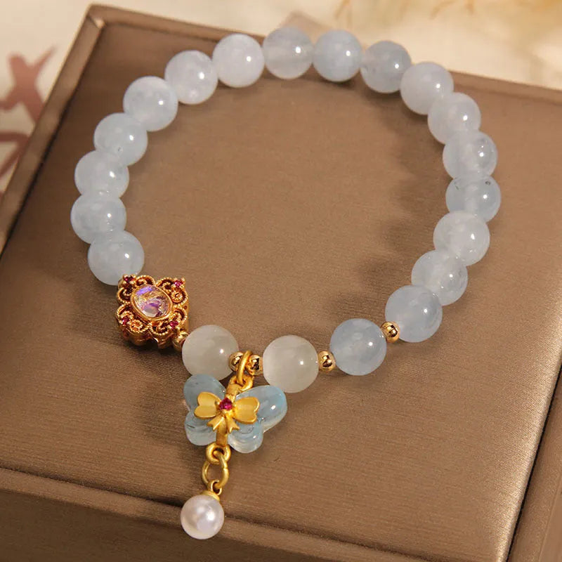 Women's crystal bracelet with a blue aquamarine butterfly pendant and sparkling rhinestone details on an adjustable chain.