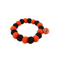 Orange cat collar with a black Halloween pumpkin print and 'trick or treat' text, shown with a buckle.
