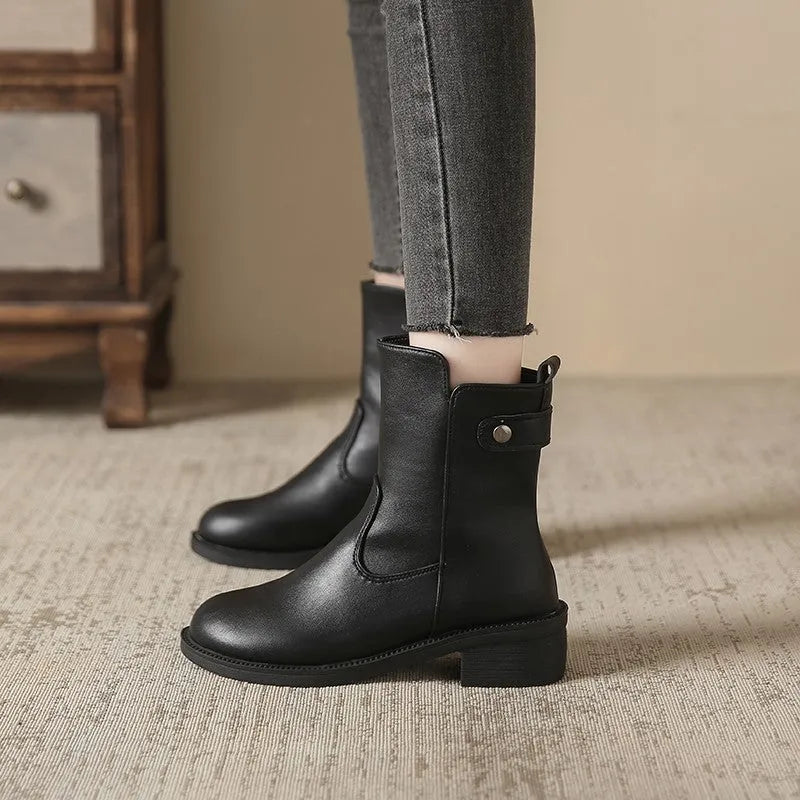 Black women's ankle boots with a side zip, round toe, and a low rubber sole.