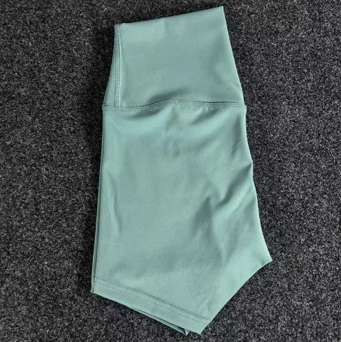 Women's high-waist nylon yoga shorts in pink litchi colour, shown for sports use.
