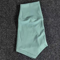 Women's high-waist nylon yoga shorts in pink litchi colour, shown for sports use.