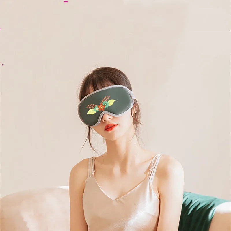 Portable eye SPA massage goggles showing super fibre material and suede shell, with USB cable connection for heating and vibration functions