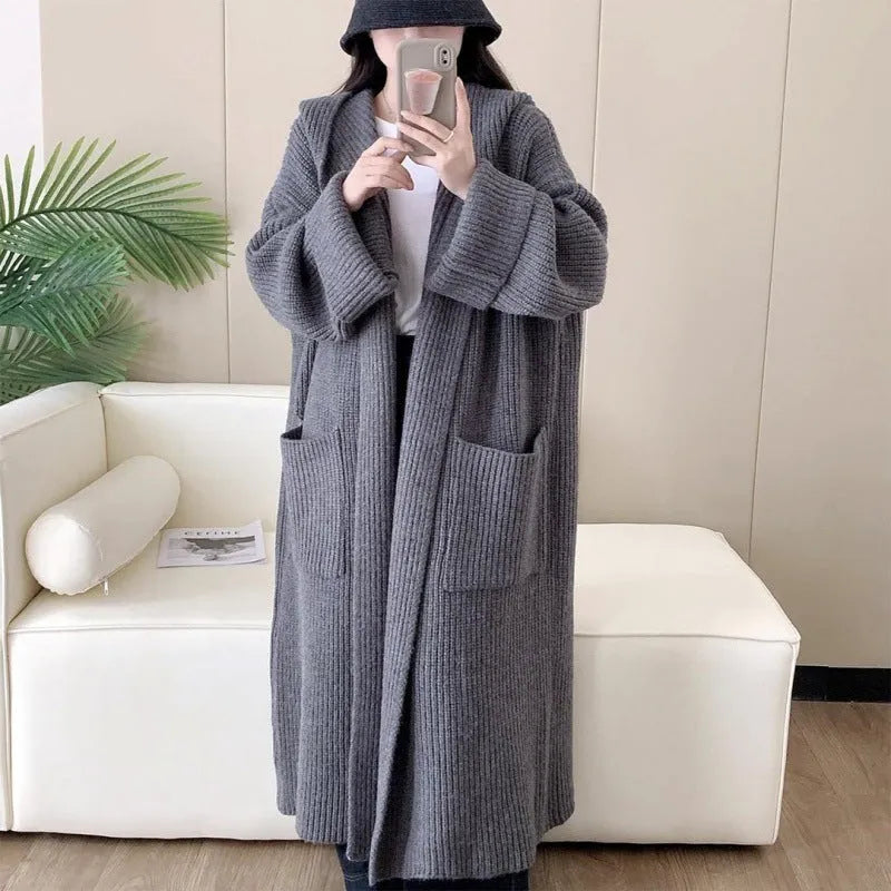 Women's loose grey hooded longline acrylic cardigan coat with raglan sleeves laid flat