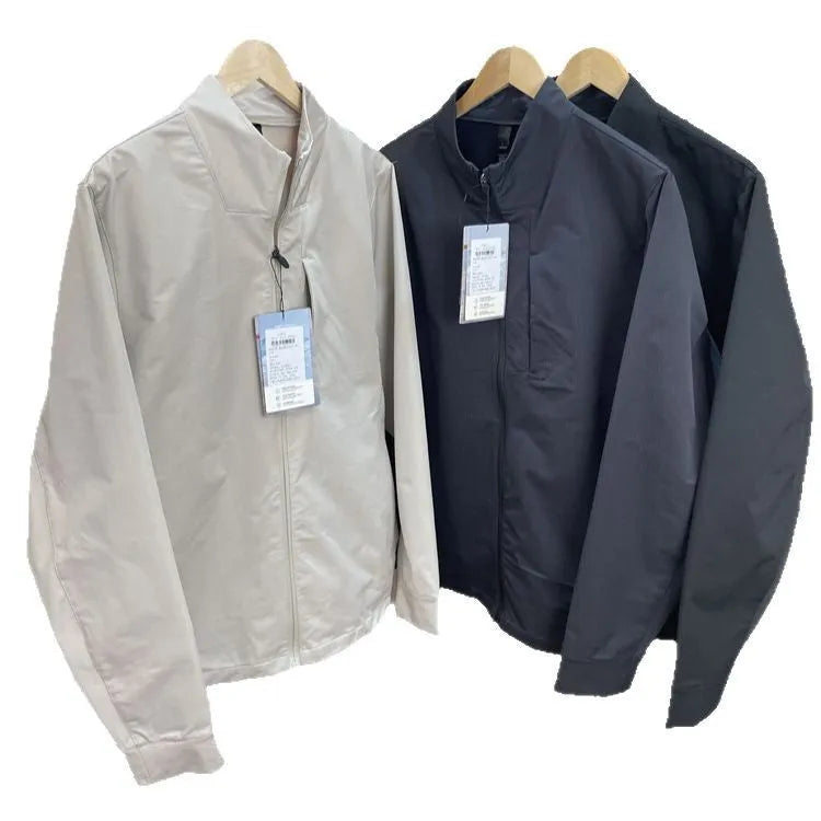 Men's beige stand collar casual sports jacket with long sleeves on a hanger.