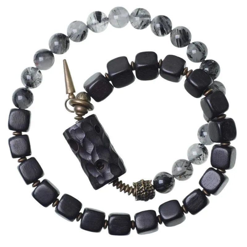 Ethnic style black hair crystal mixed handmade texture bracelet on a neutral background