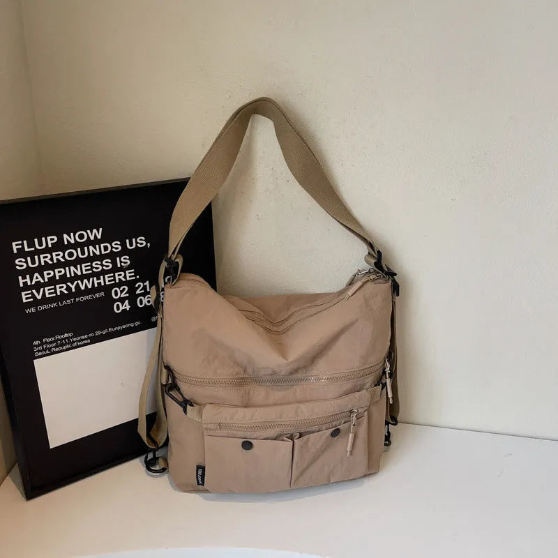 Women's nylon crossbody bag in square vertical shape with double shoulder straps and organised interior compartments