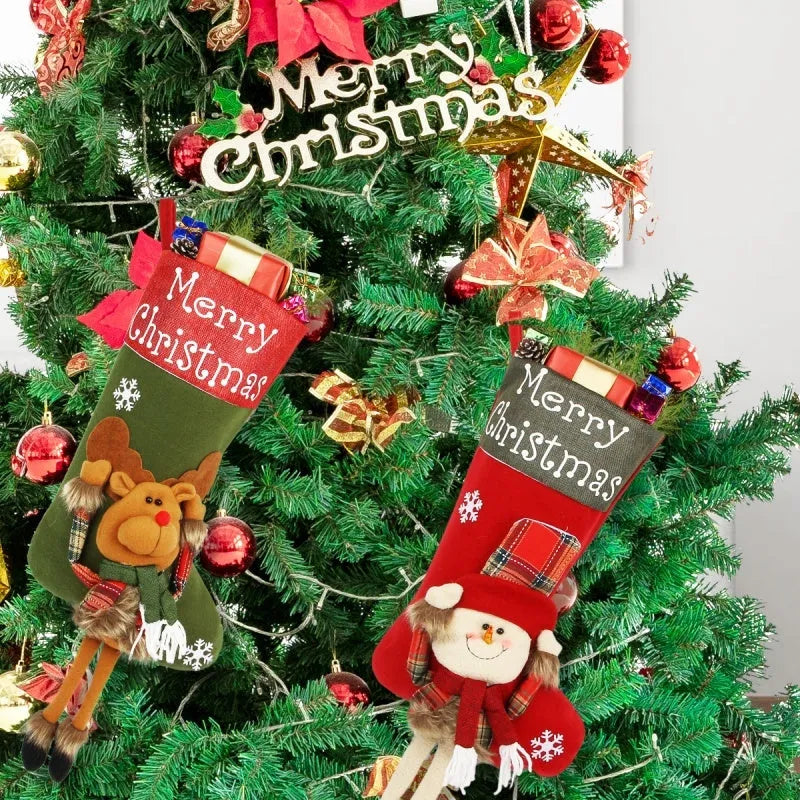 Three large Christmas stockings with Santa Snowman Reindeer 3D plush designs for holiday tree decoration
